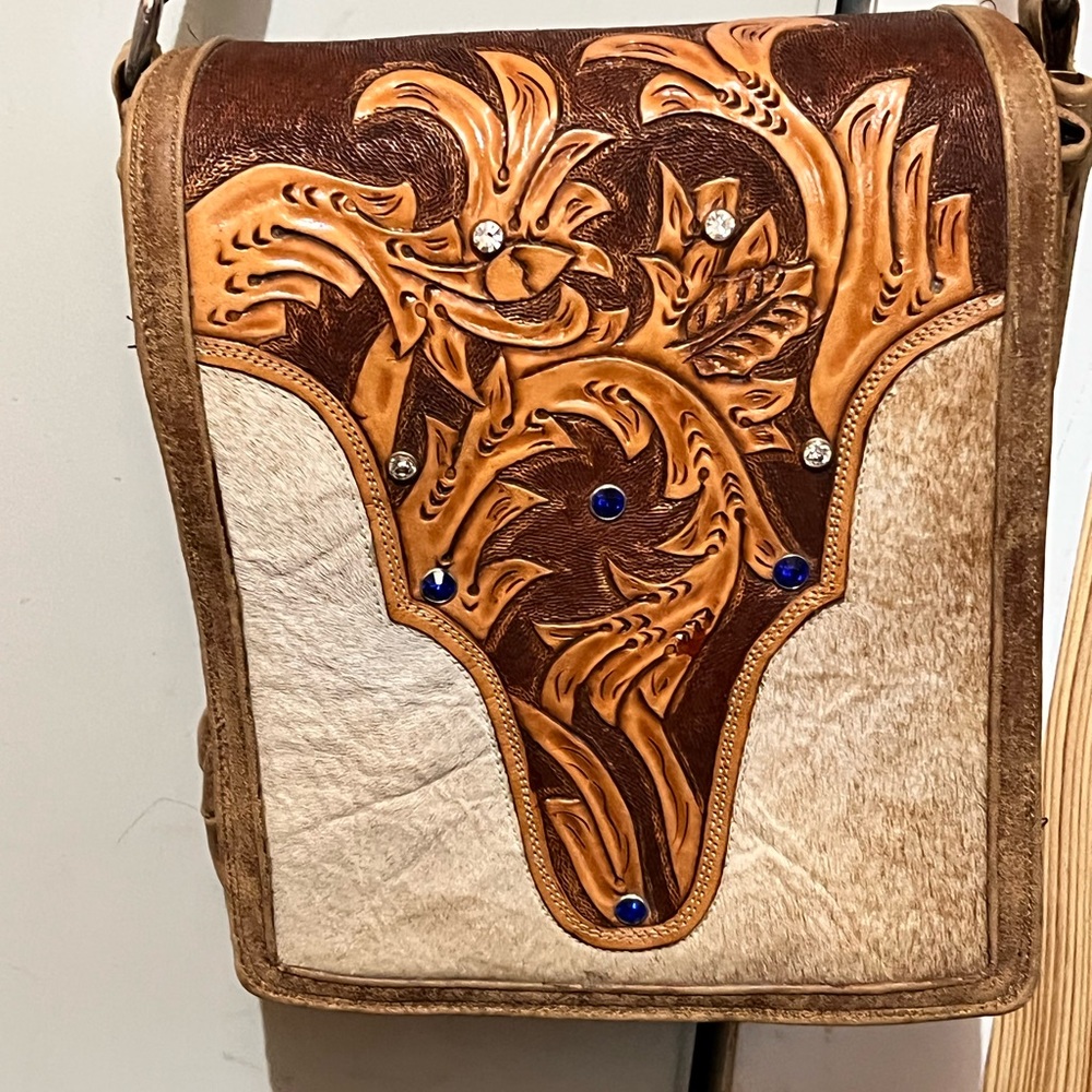 I am selling this crossbody cowhide and leather bag